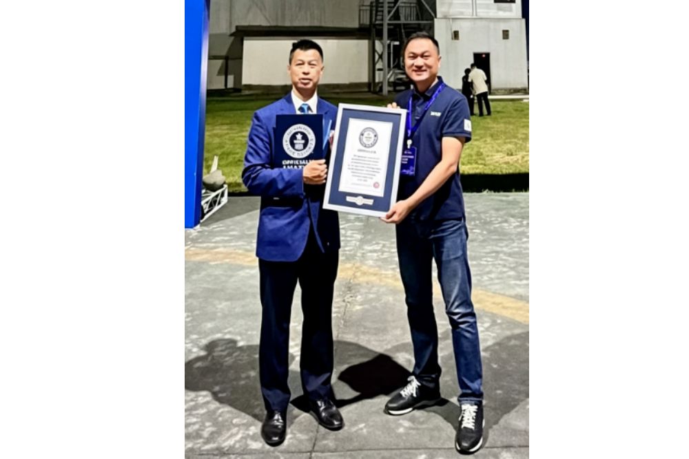 Guinness World Records adjudicator poses for a photo with FILMBASE staff.jpg